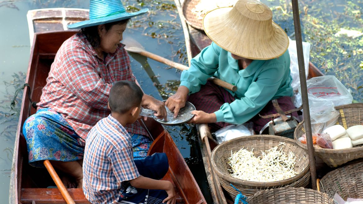 See the locals selling their products on the boat 