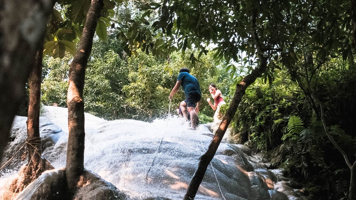 Grab the robes and climb on Bua Tong Waterfalls 