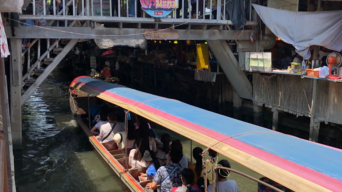 Traveling for sightseeing along the small canal by the long tailed boat 