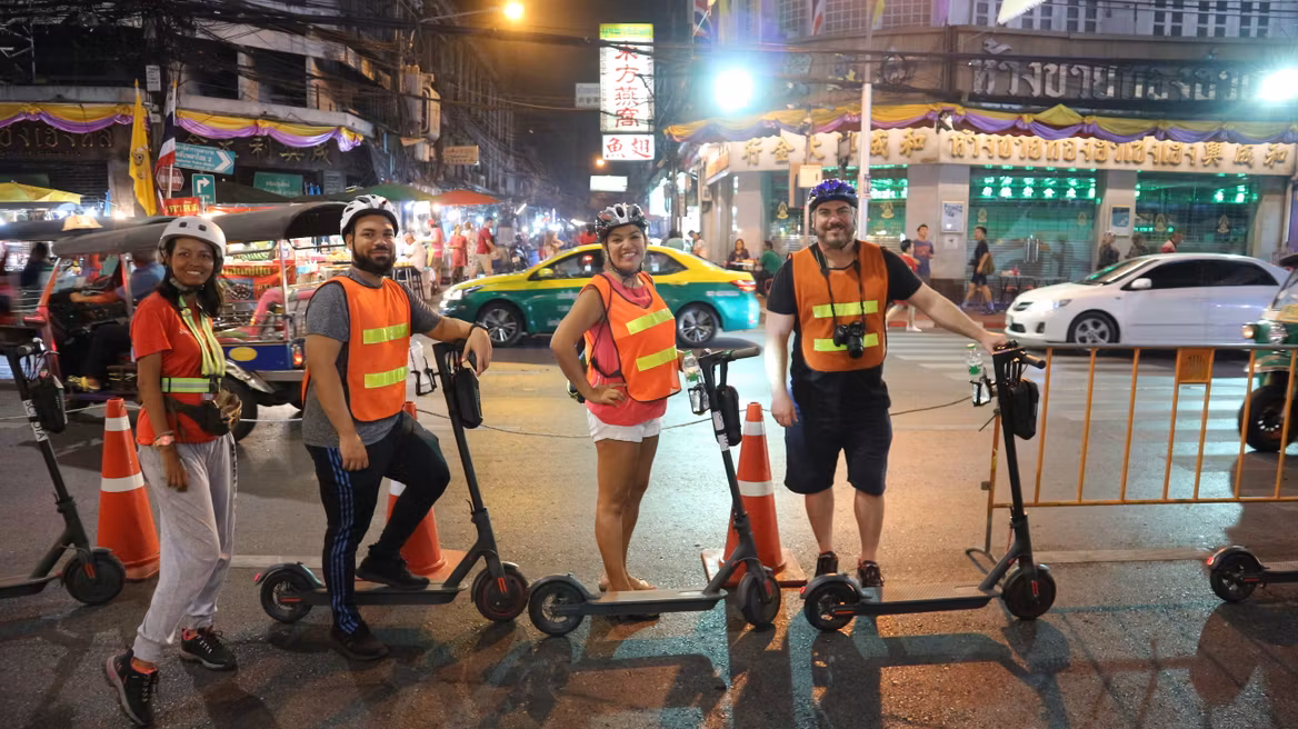 Join a group to scooter around Bangkok at night