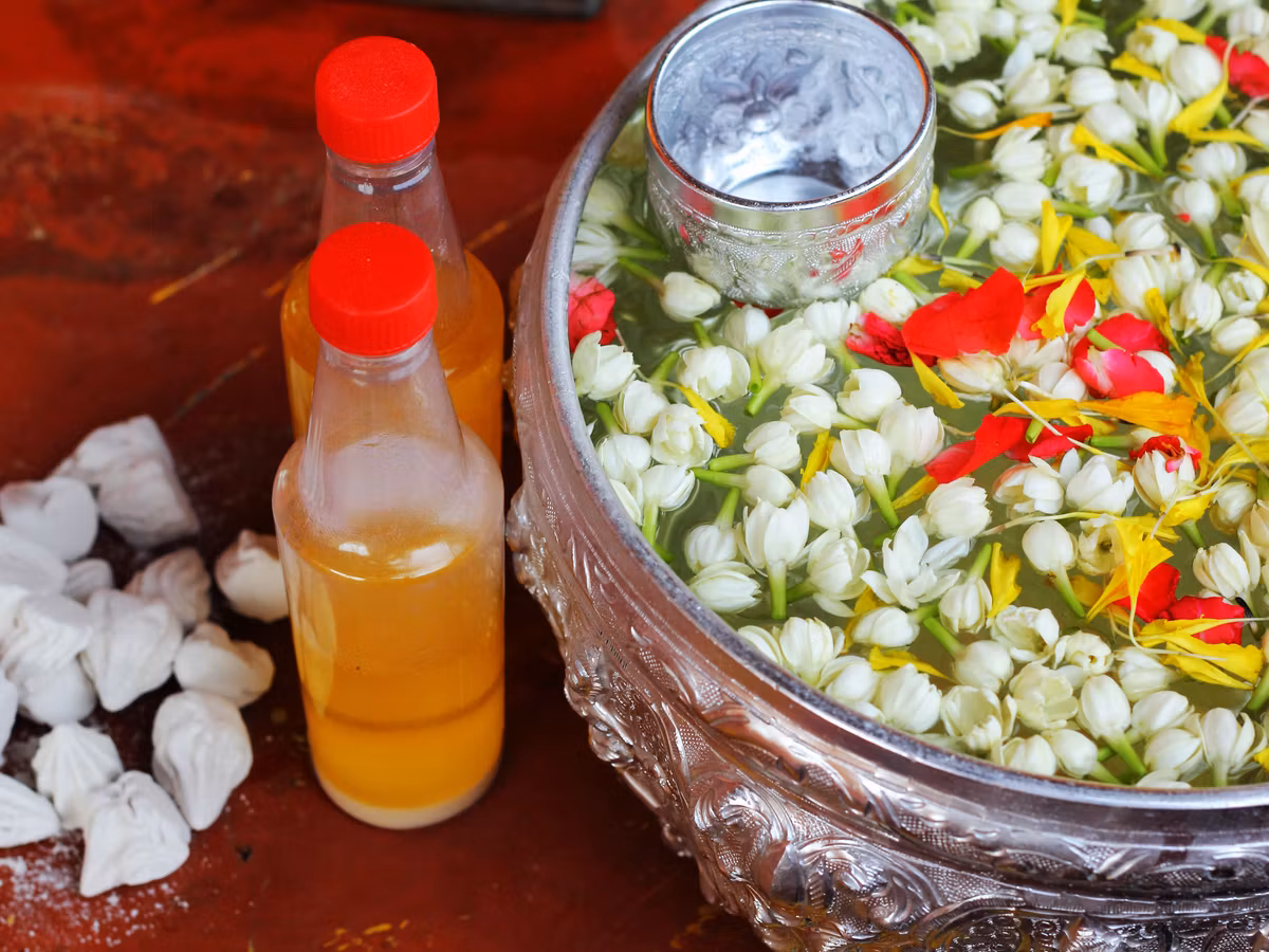 Songkran Festival: Scented water, flowers and silver bowl, traditional beauty of Thai New Year