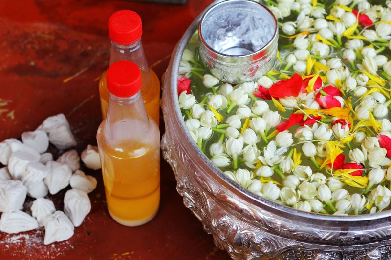 Songkran Festival: Scented water, flowers and silver bowl, traditional beauty of Thai New Year